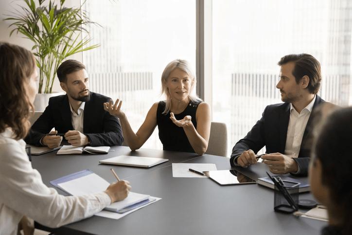 Comité de dirección en una reunión tensa evaluando el rendimiento de un directivo